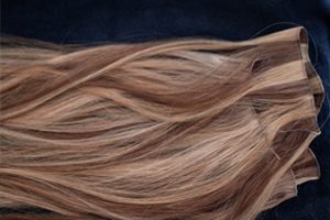 hand tied hair extensions being used by an individual